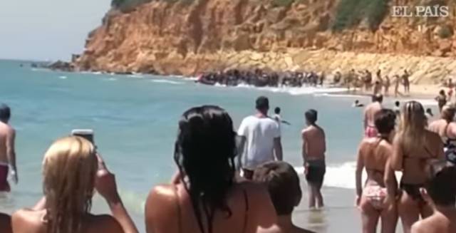 Video: Migrant boat arrives on tourist-filled beach in Cádiz