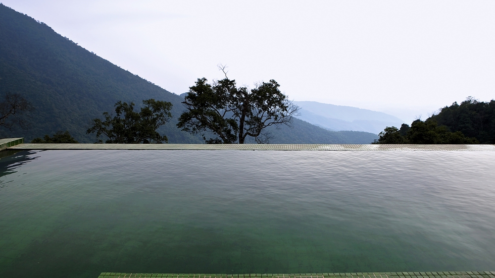 Desde la piscina se pueden contemplar las montañas del parque natural de Tam Dao. Los mosaicos verdes dan continuidad visual al paisaje.