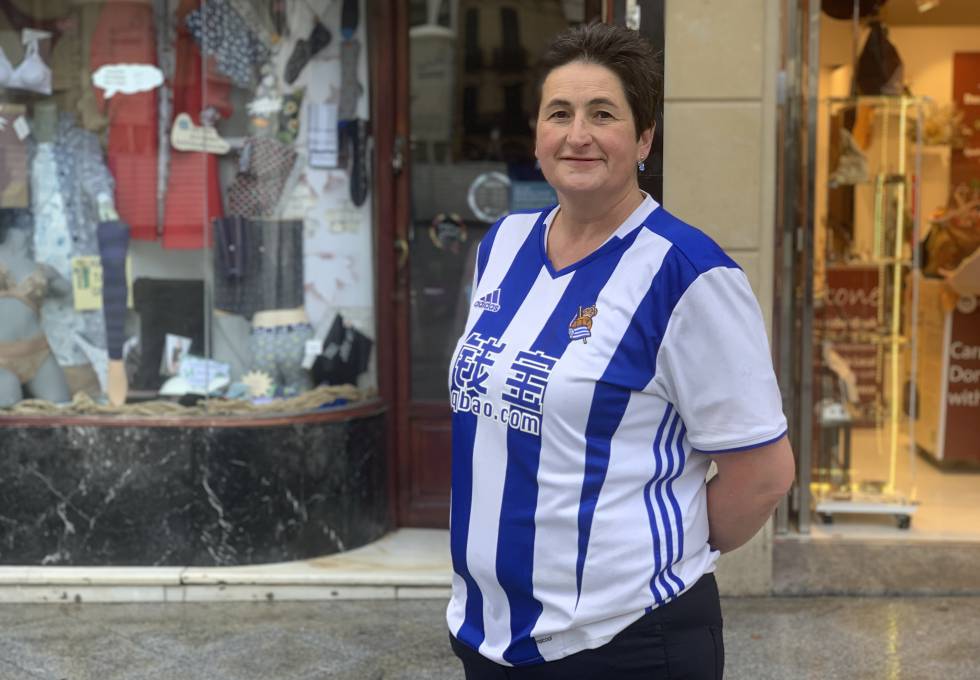 Arantxa Aristizabal con la camiseta de la Real Sociedad, en la puerta de su local de medias y ropa interior, en la Parte Vieja de Donostia.